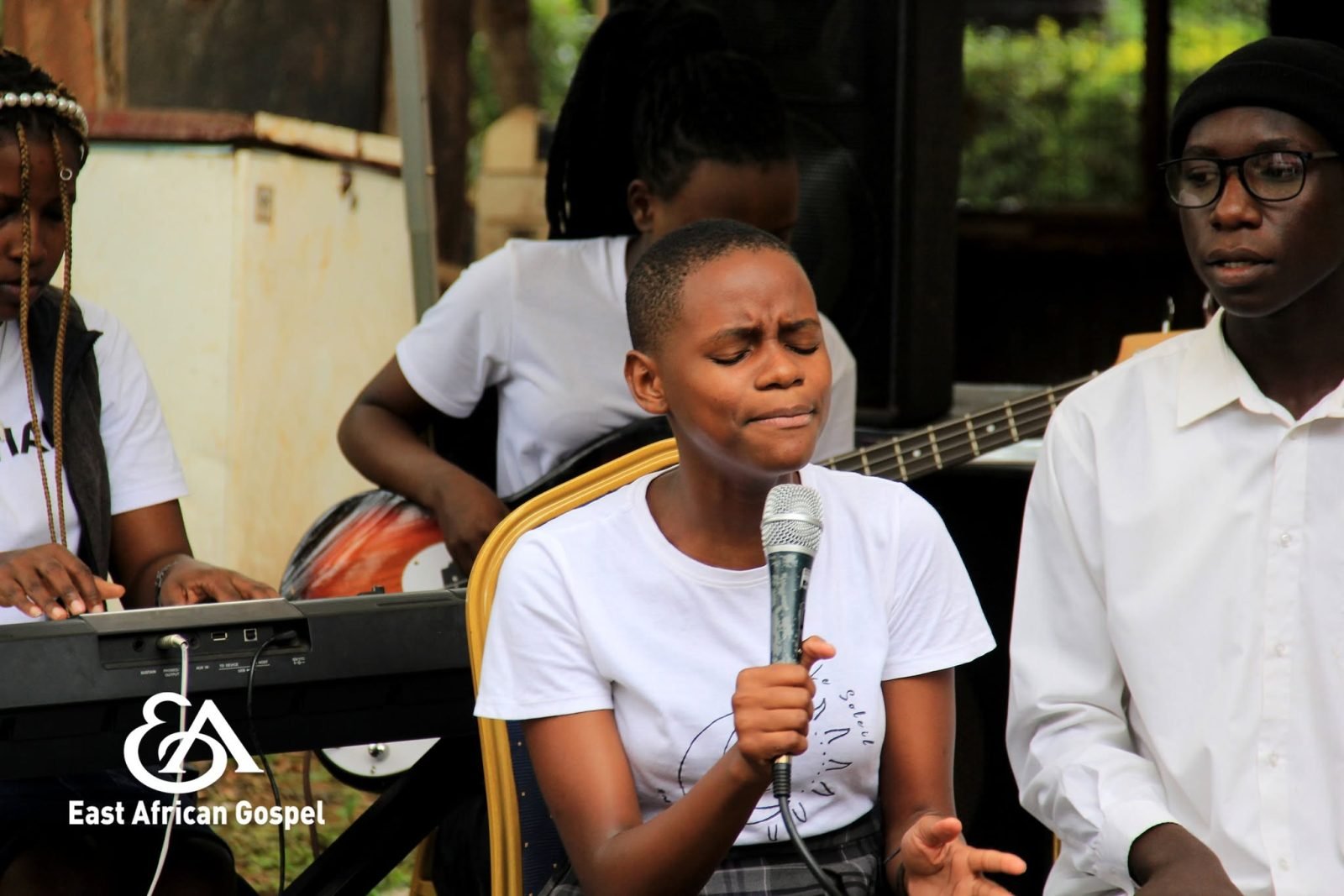 A worship leader singing at a worship night
